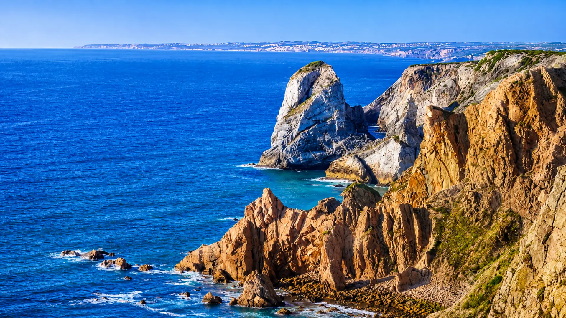 Rocky cliffs overlooking the Atlantic Ocean along the coast of Portugal.
