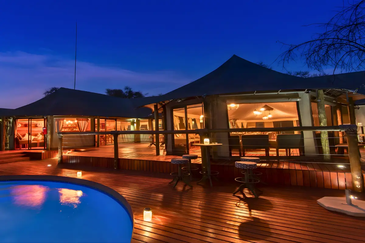 Evening view of the deck and pool at Tau Lodge in South Africa.