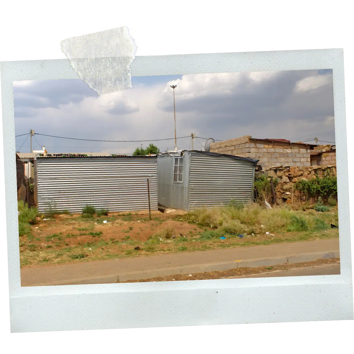 Polaroid-style image of a corrugated metal house in Soweto.