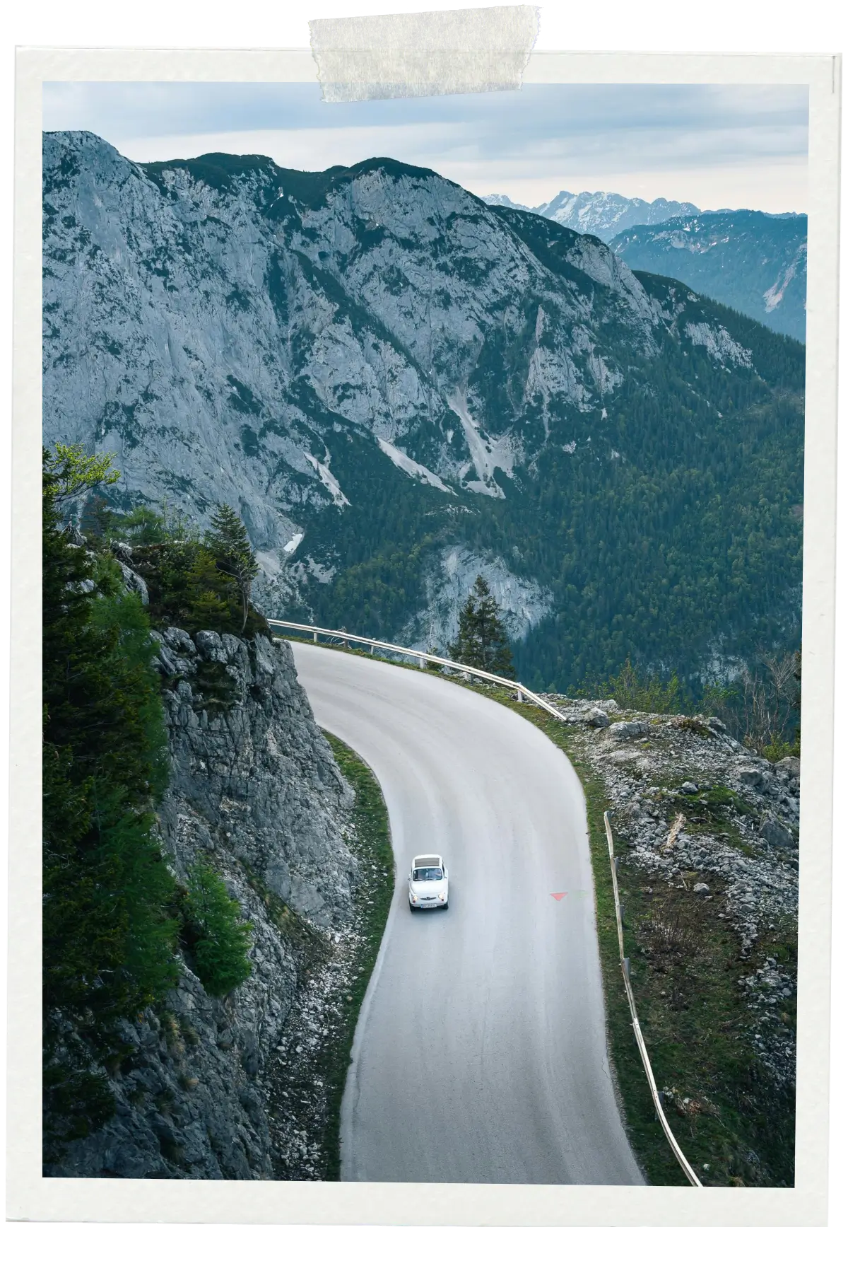 Winding mountain road cutting through the Austrian Alps.