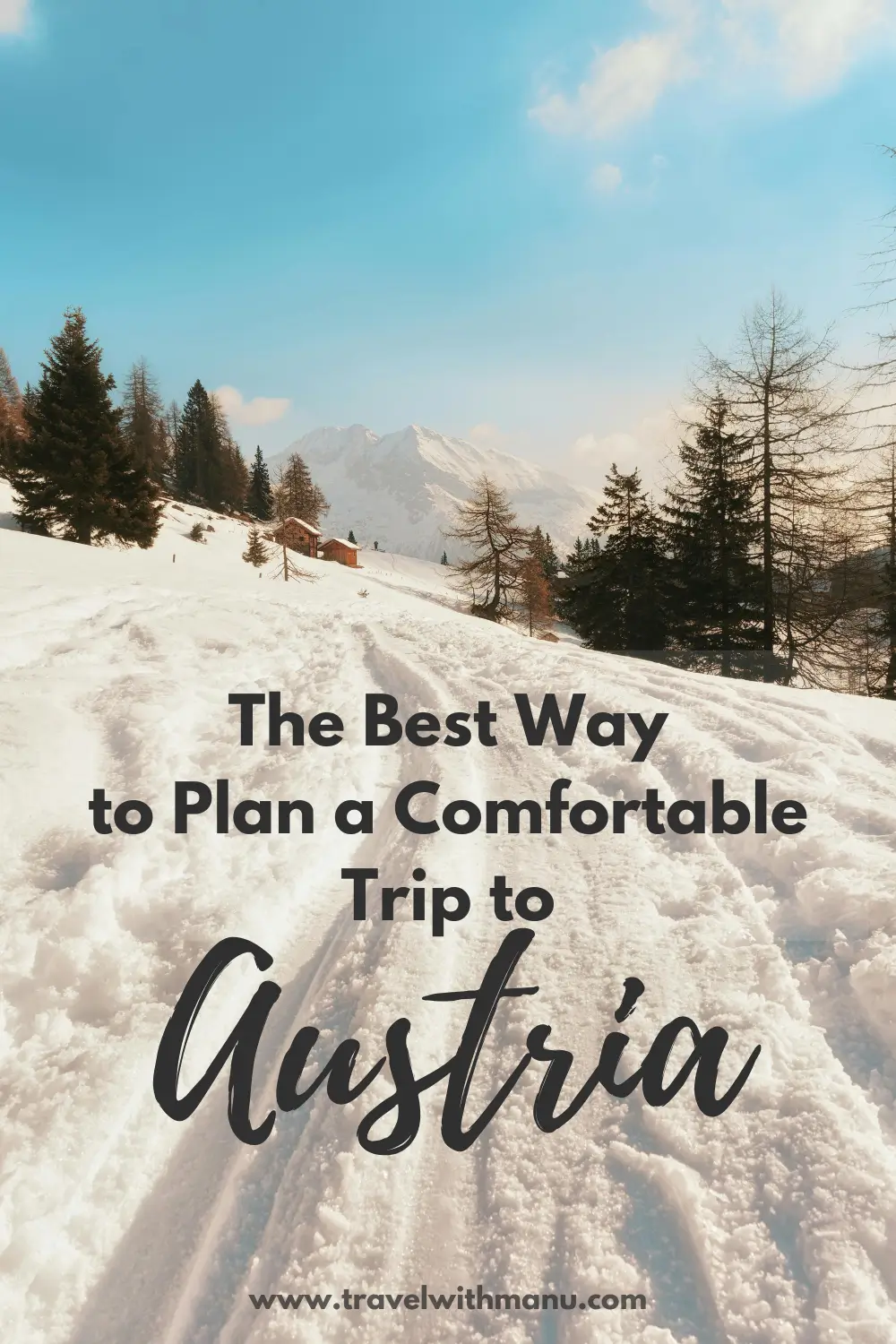 Snowy mountain landscape in Austria with a winter walking path and alpine cabins.