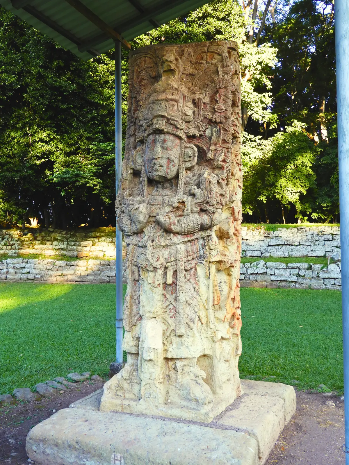 Carved Maya stone stele standing at the Copán archaeological site in Honduras.