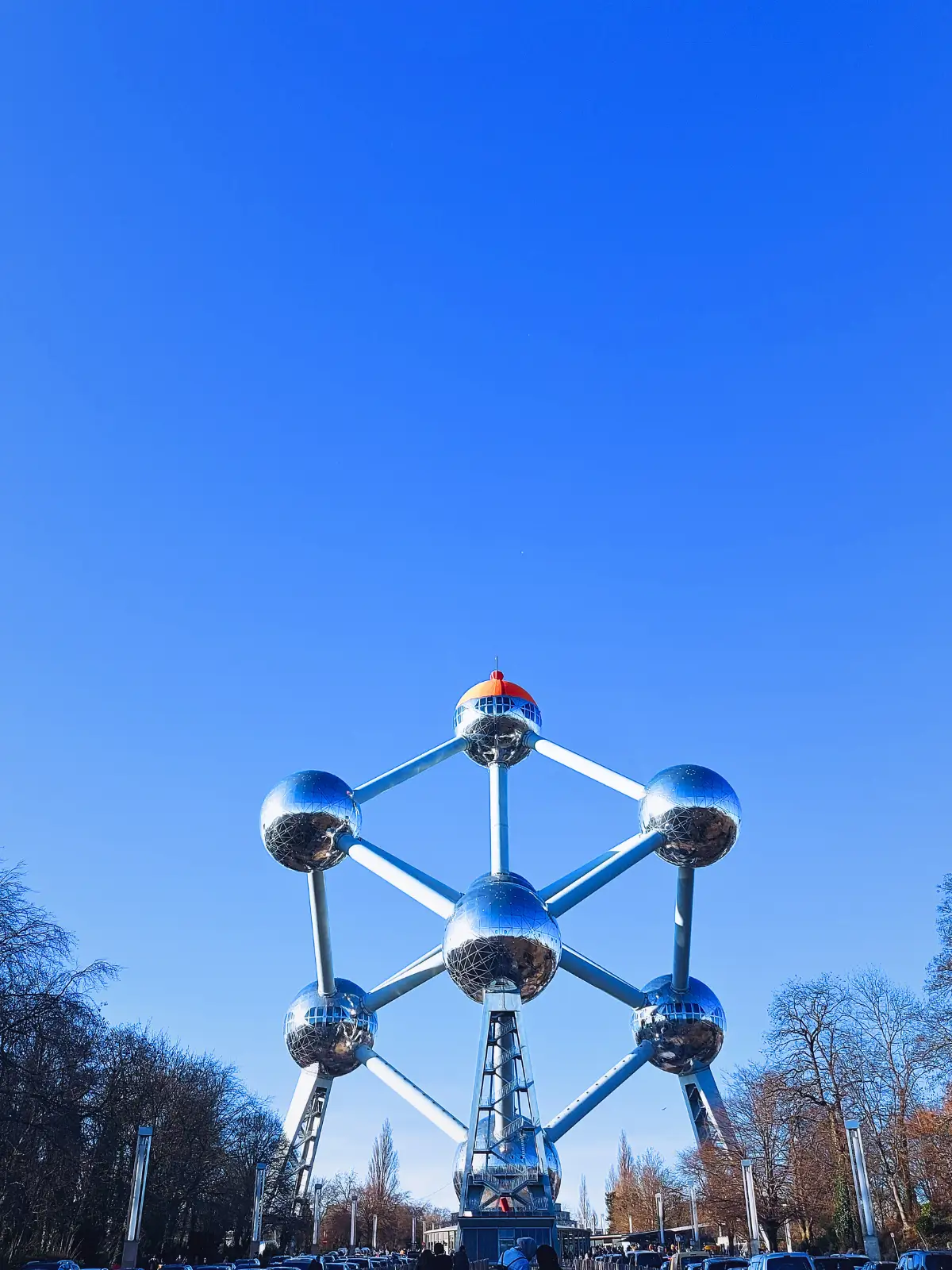 Colourful historic houses and small boats along a canal in Bruges.