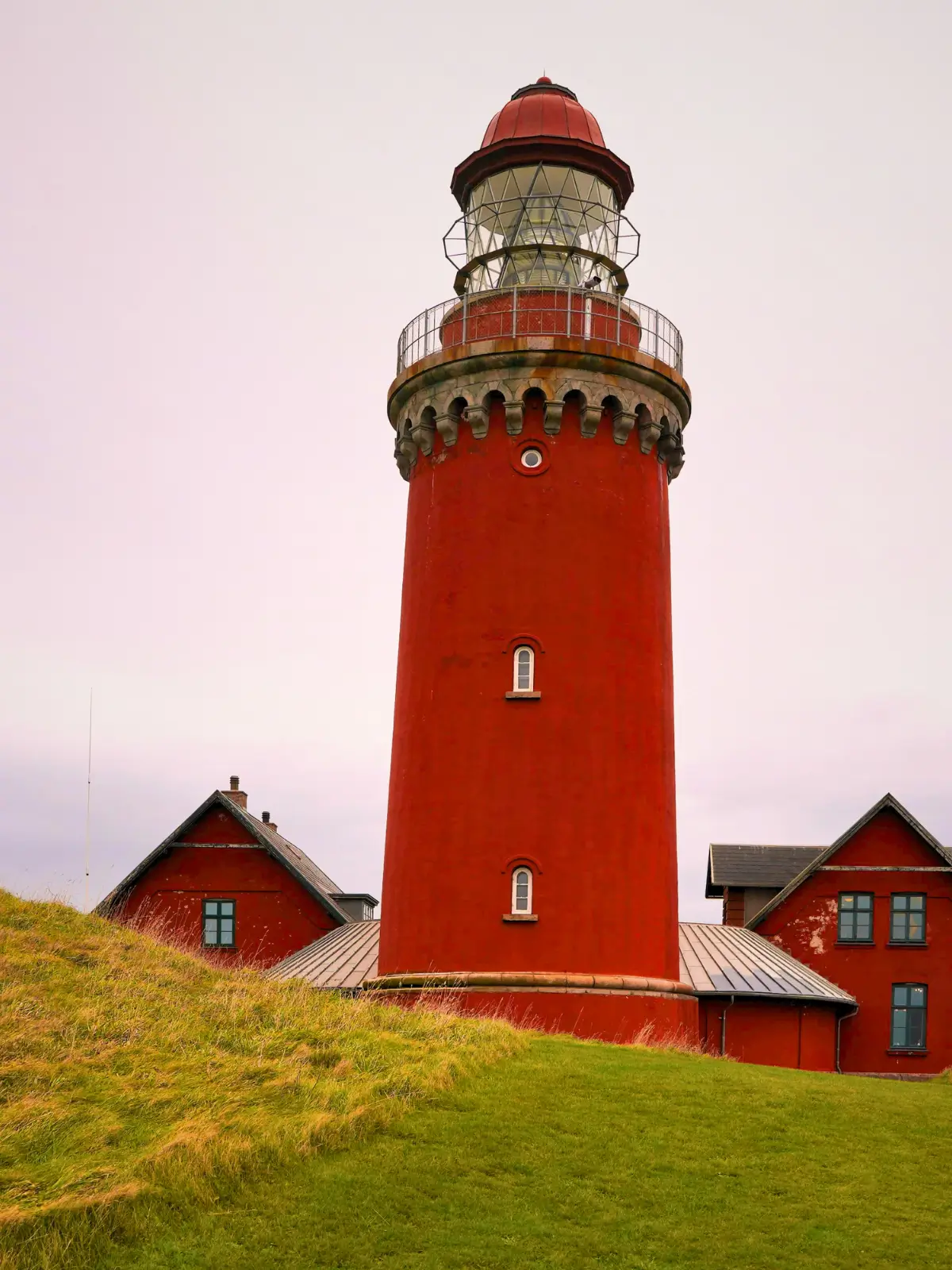 Blåvandshuk Lighthouse on grassy coastal dunes in western Denmark.
