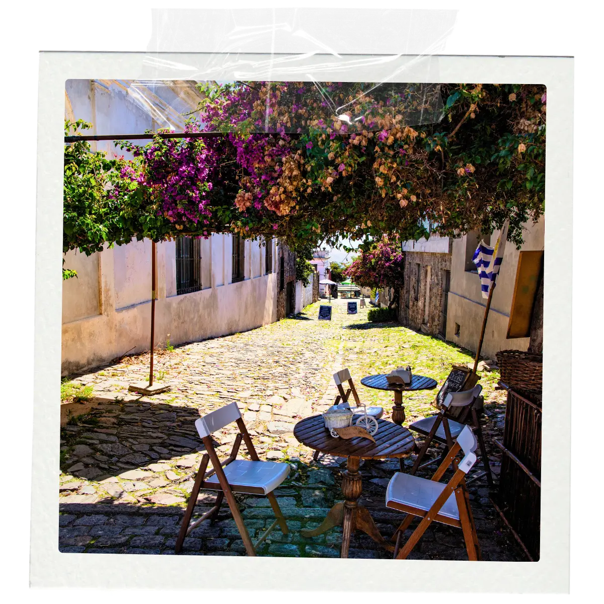 Outdoor café table on a cobblestone street in Colonia del Sacramento’s historic district, Uruguay.