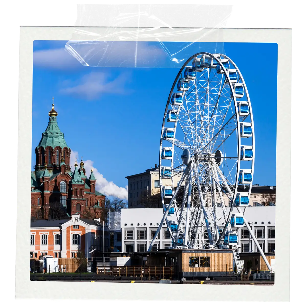 Ferris wheel and cathedral skyline along the Helsinki harbour in Finland.