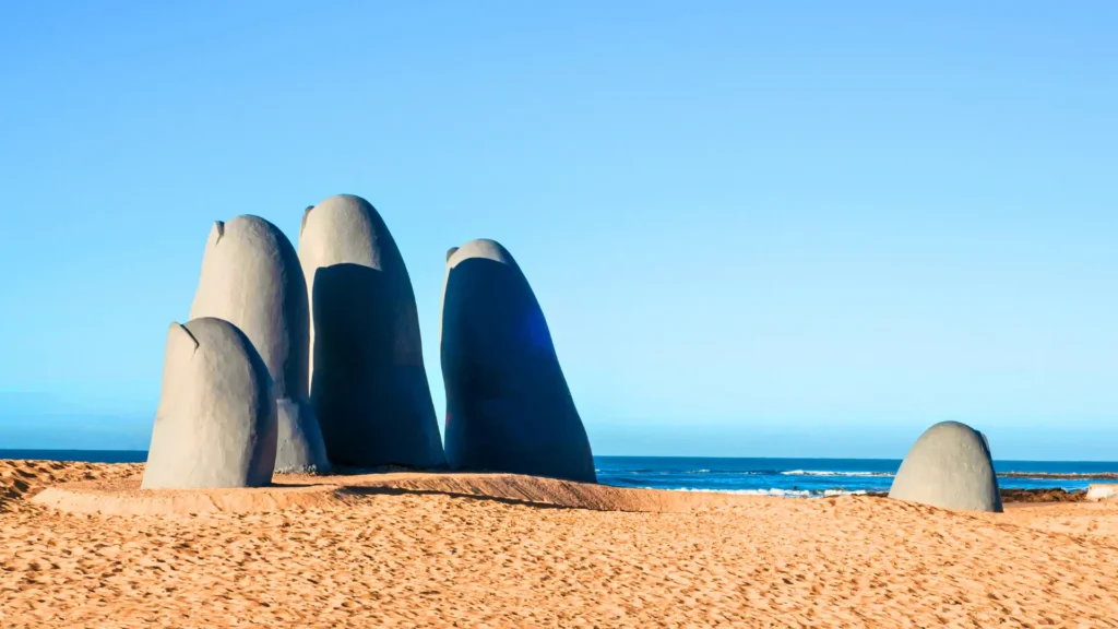 La Mano giant hand sculpture rising from the sand on Punta del Este beach.