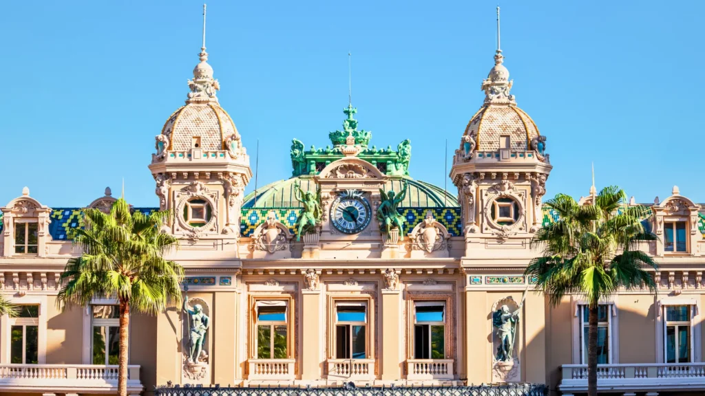 Monte Carlo Casino facade with ornate architecture and palm trees.
