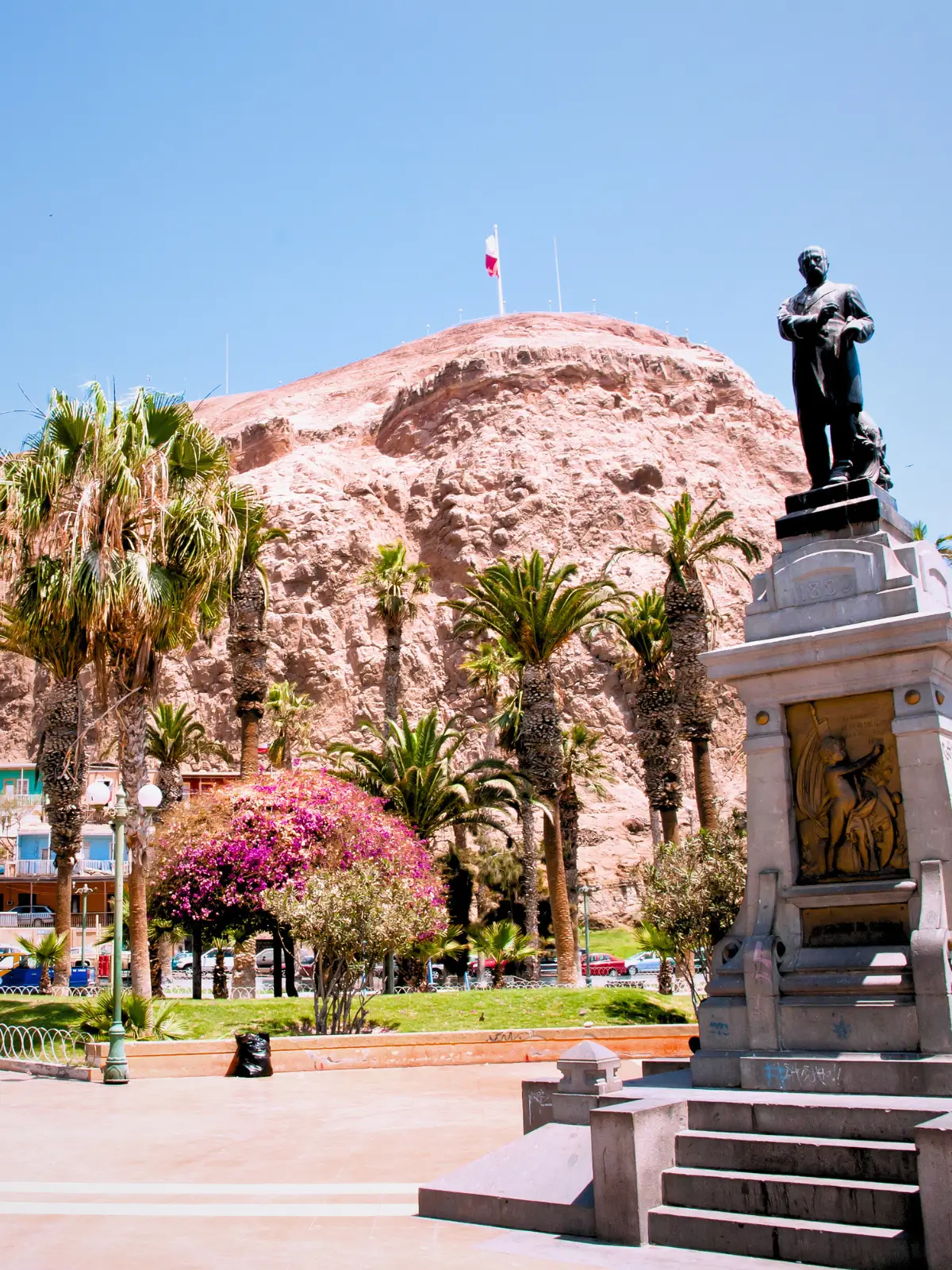Monument at Morro de Arica hill with Chilean flag overlooking the city in northern Chile.