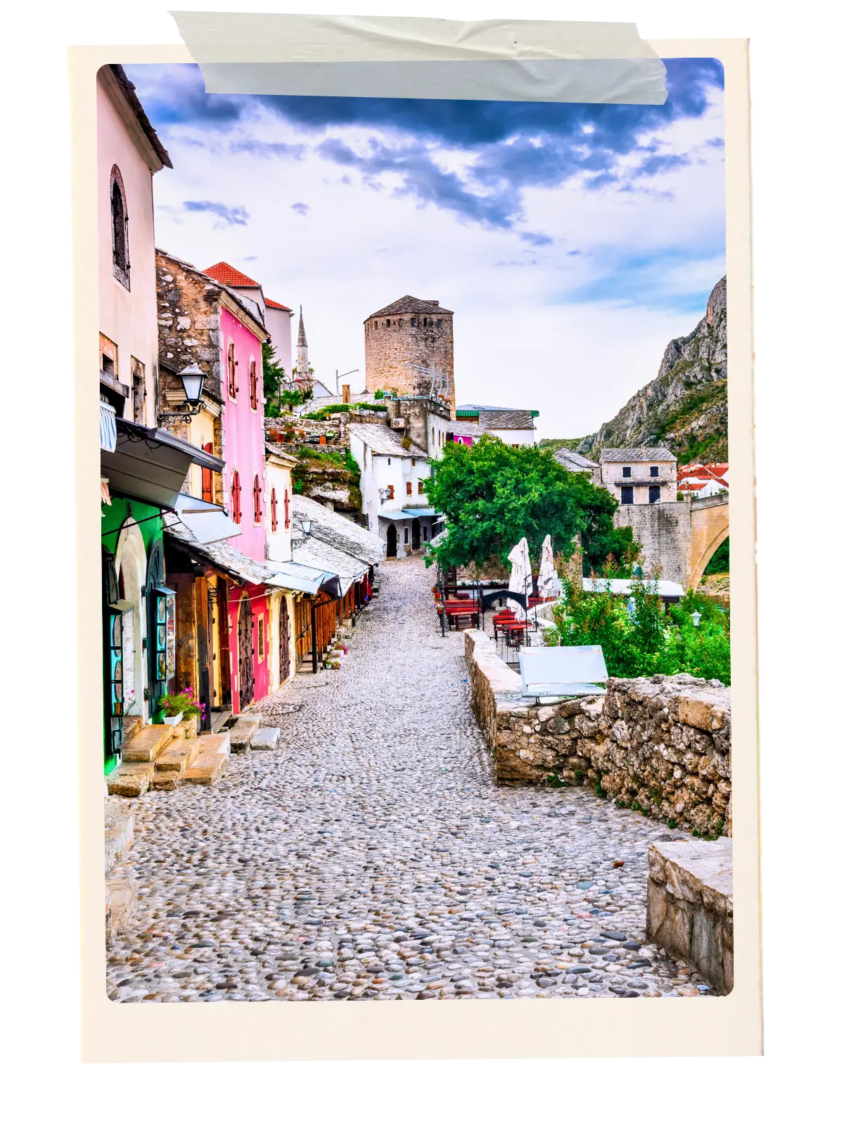 Colourful buildings along a cobblestone street in Mostar Old Town near Stari Most bridge.