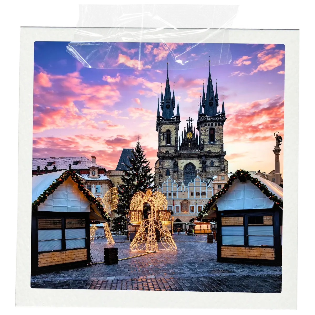 Christmas market in Prague Old Town Square with festive lights and church towers in Czech Republic.