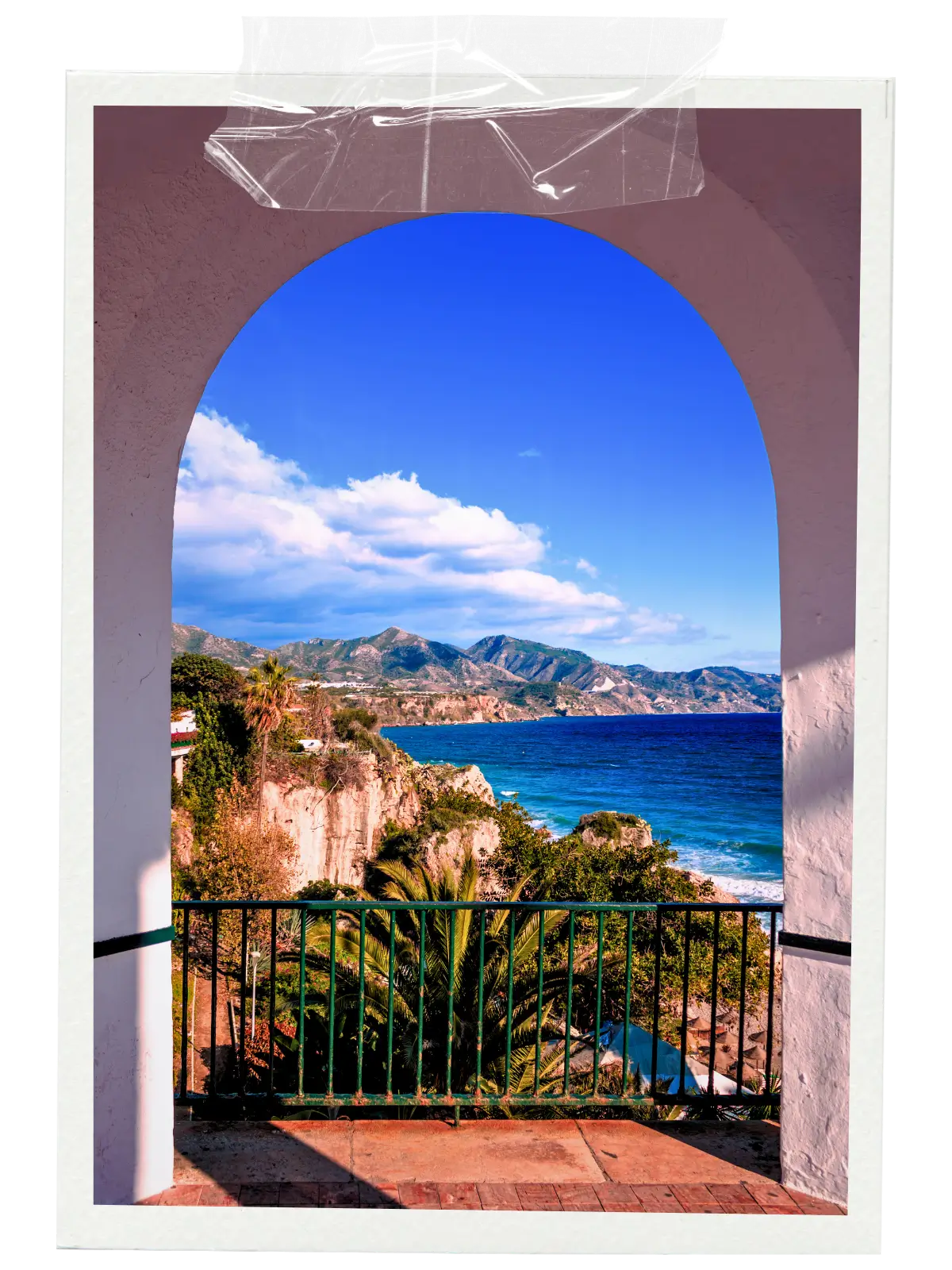 View from Balcón de Europa in Nerja overlooking cliffs, coastline, and Mediterranean Sea through an arched opening.