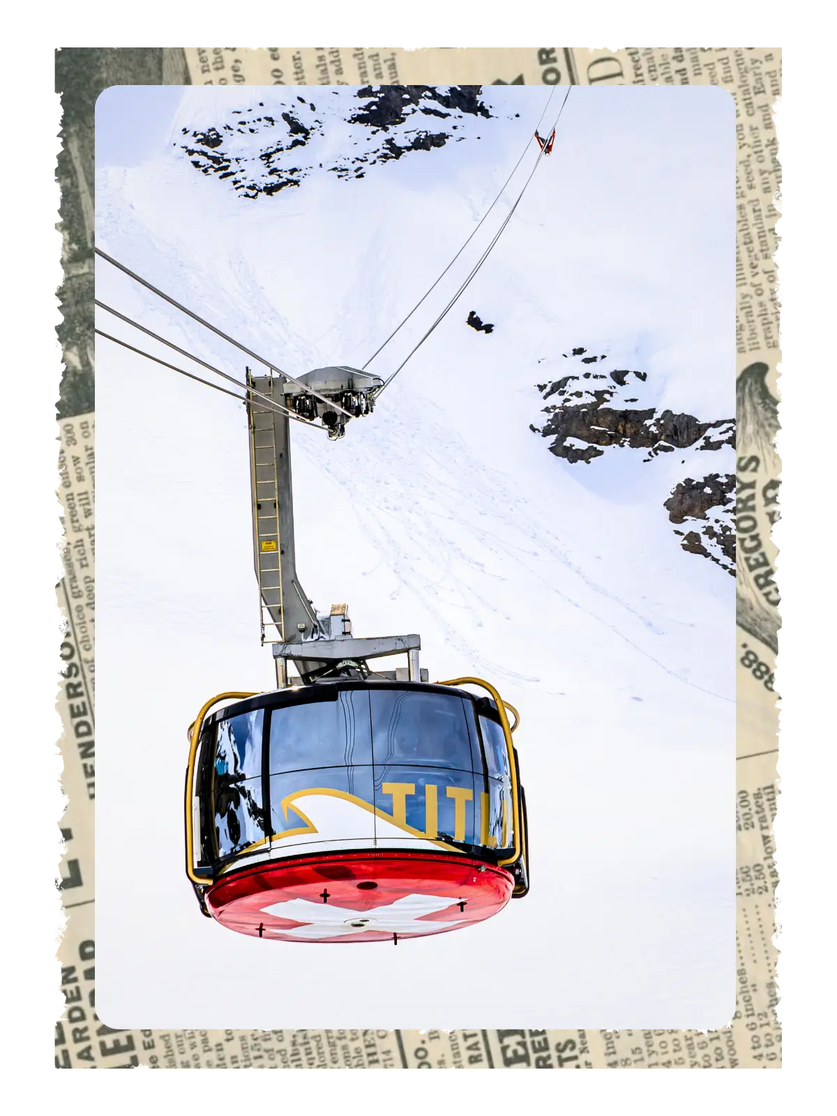 Cable car ascending snowy slopes on Mount Titlis with alpine terrain below.