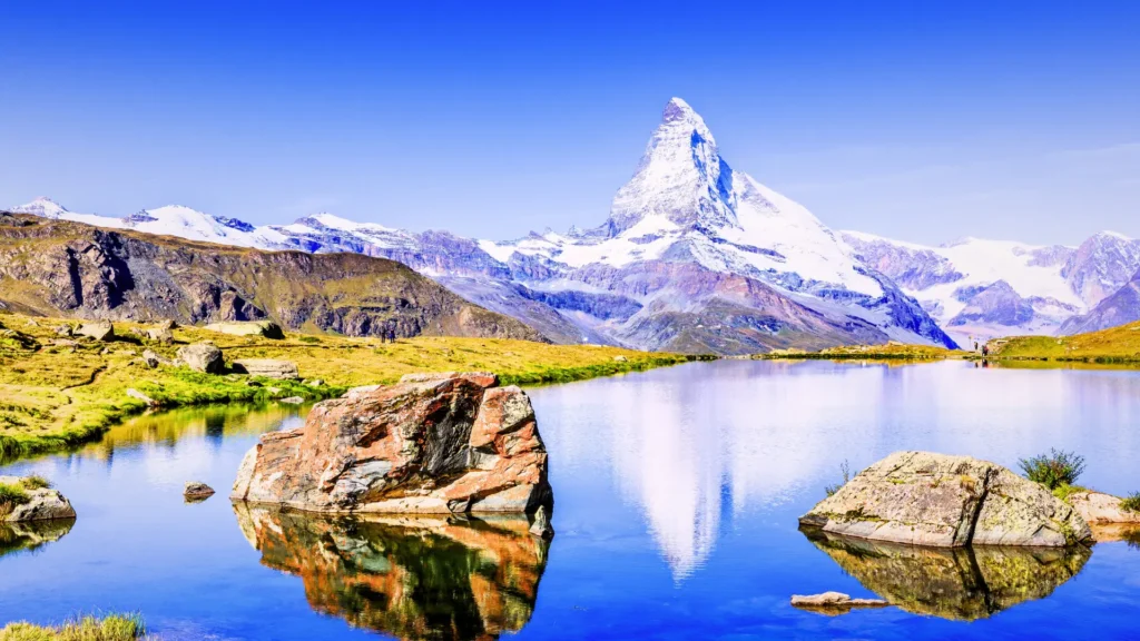 Matterhorn reflected in Stellisee lake near Zermatt with clear mountain views.