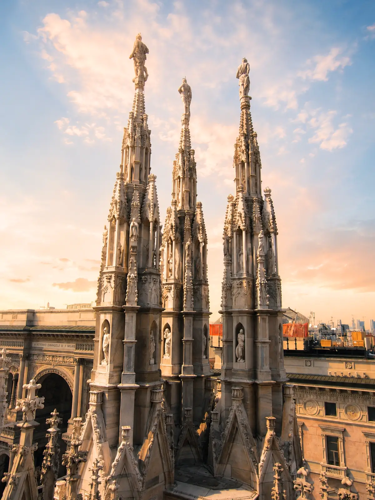 Gothic spires on the rooftop of Milan Cathedral at sunset.