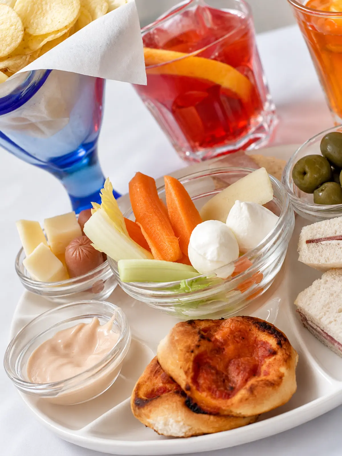 Italian aperitivo snacks and drinks served at a table.