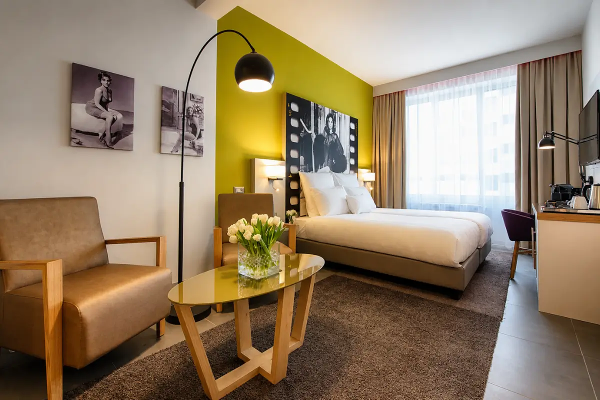 Modern room interior at NYX Hotel Milan with stylish décor and warm lighting.