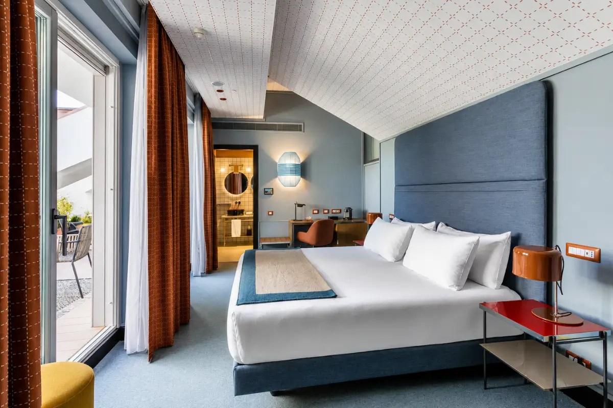 Stylish room at Room Mate Collection Giulia in Milan with modern decor and terrace access.