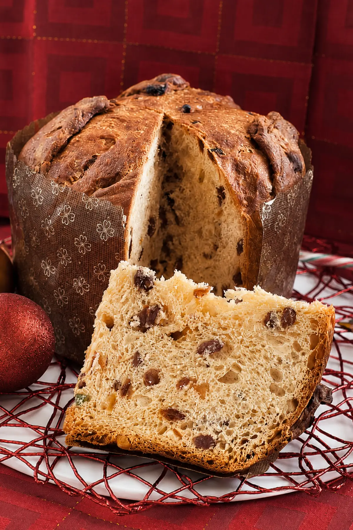 Traditional Italian panettone with a sliced piece.