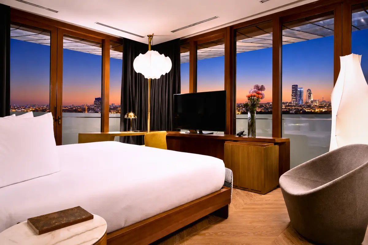Vertical Boutique Hotel Milan room with city views at dusk.