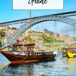 Rabelo boat on the Douro River with Dom Luís I Bridge in Porto behind it.