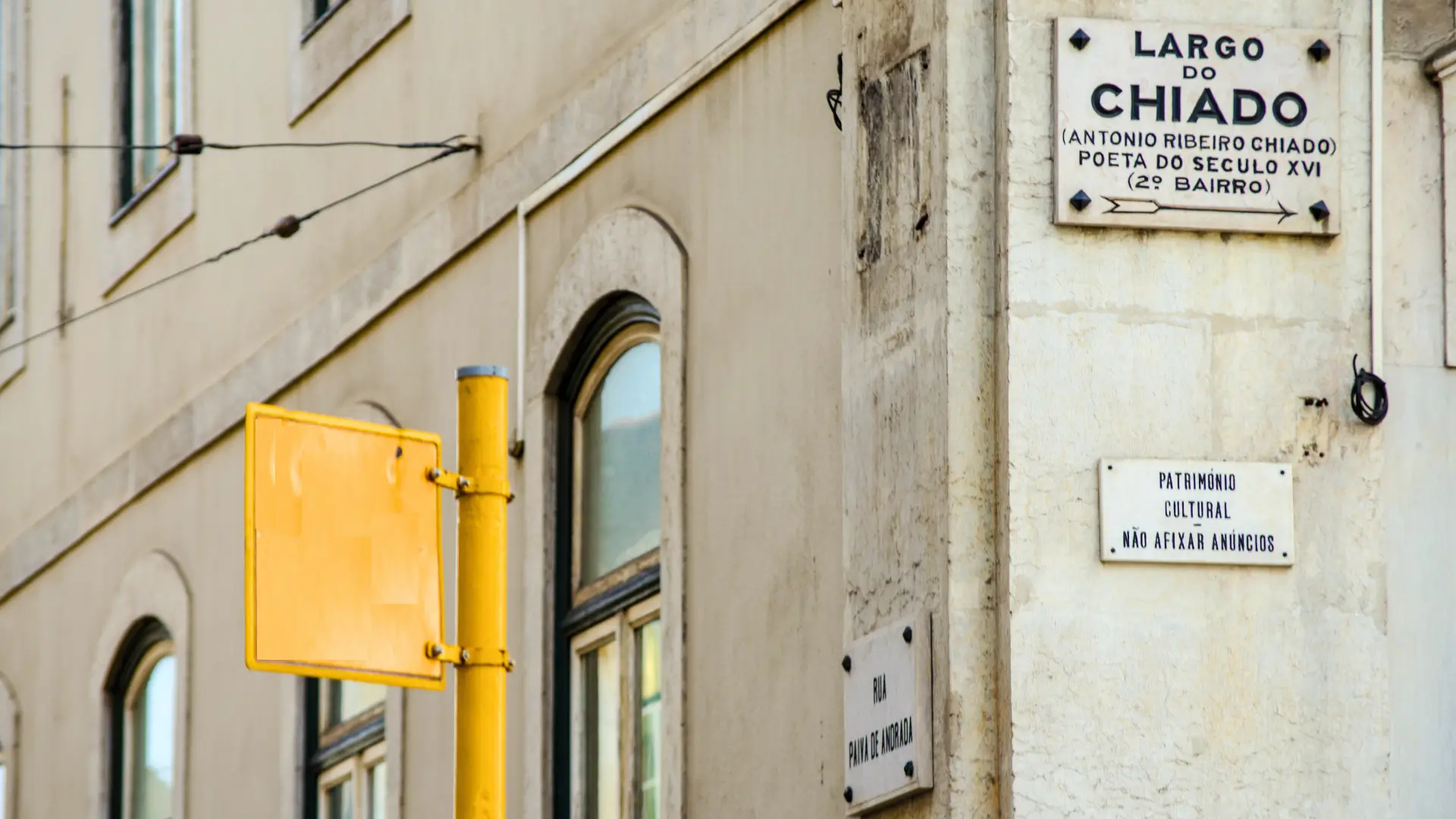 Street sign for Largo do Chiado on a cream-coloured building in Lisbon.