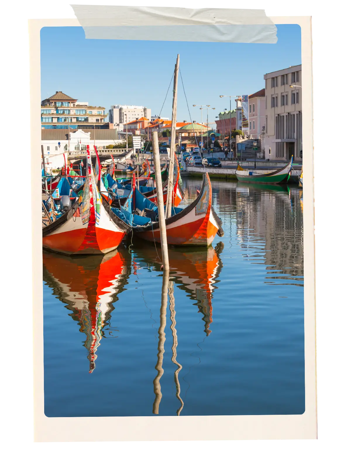 Colourful moliceiro boats moored along a canal in Aveiro, Portugal.