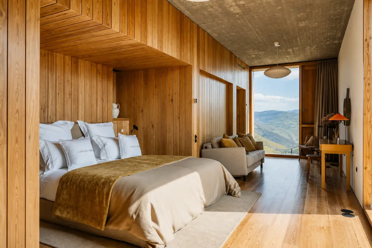 Wood-panelled bedroom with Douro Valley views at Casa do Arco.