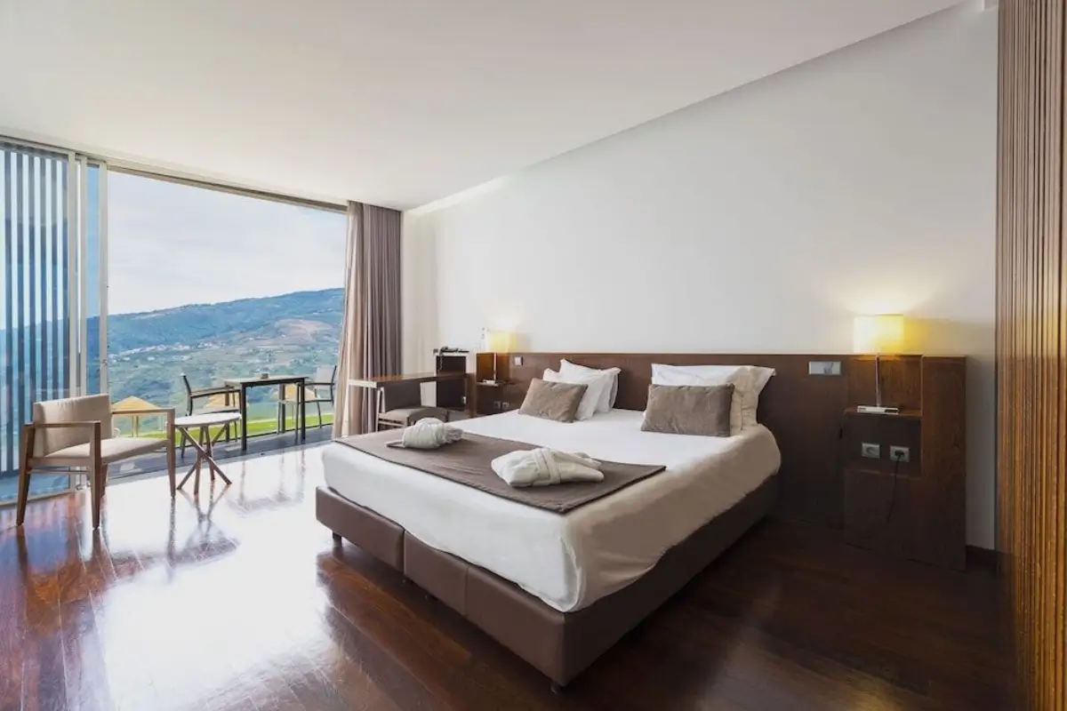 Douro Scala Hotel room with floor-to-ceiling windows overlooking the Douro Valley.