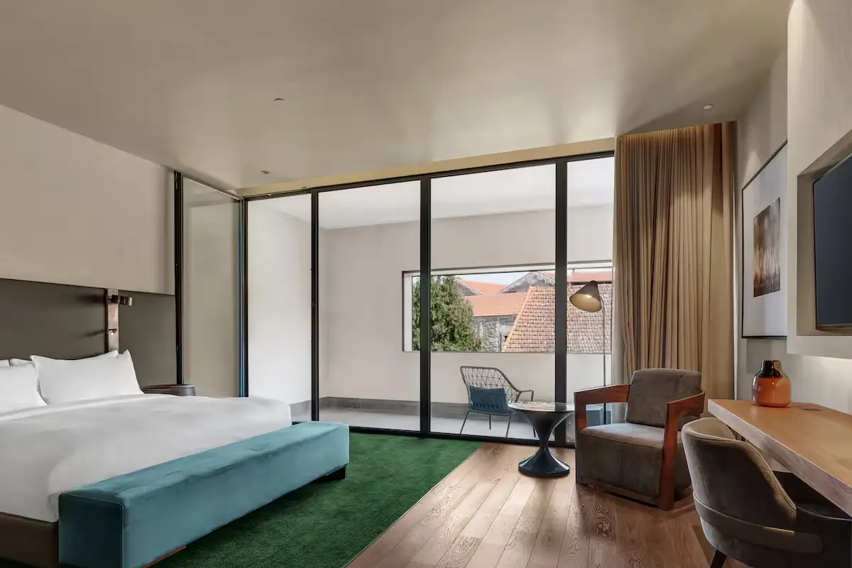 Spacious room at Hilton Porto Gaia with a large bed, private terrace and contemporary furnishings.