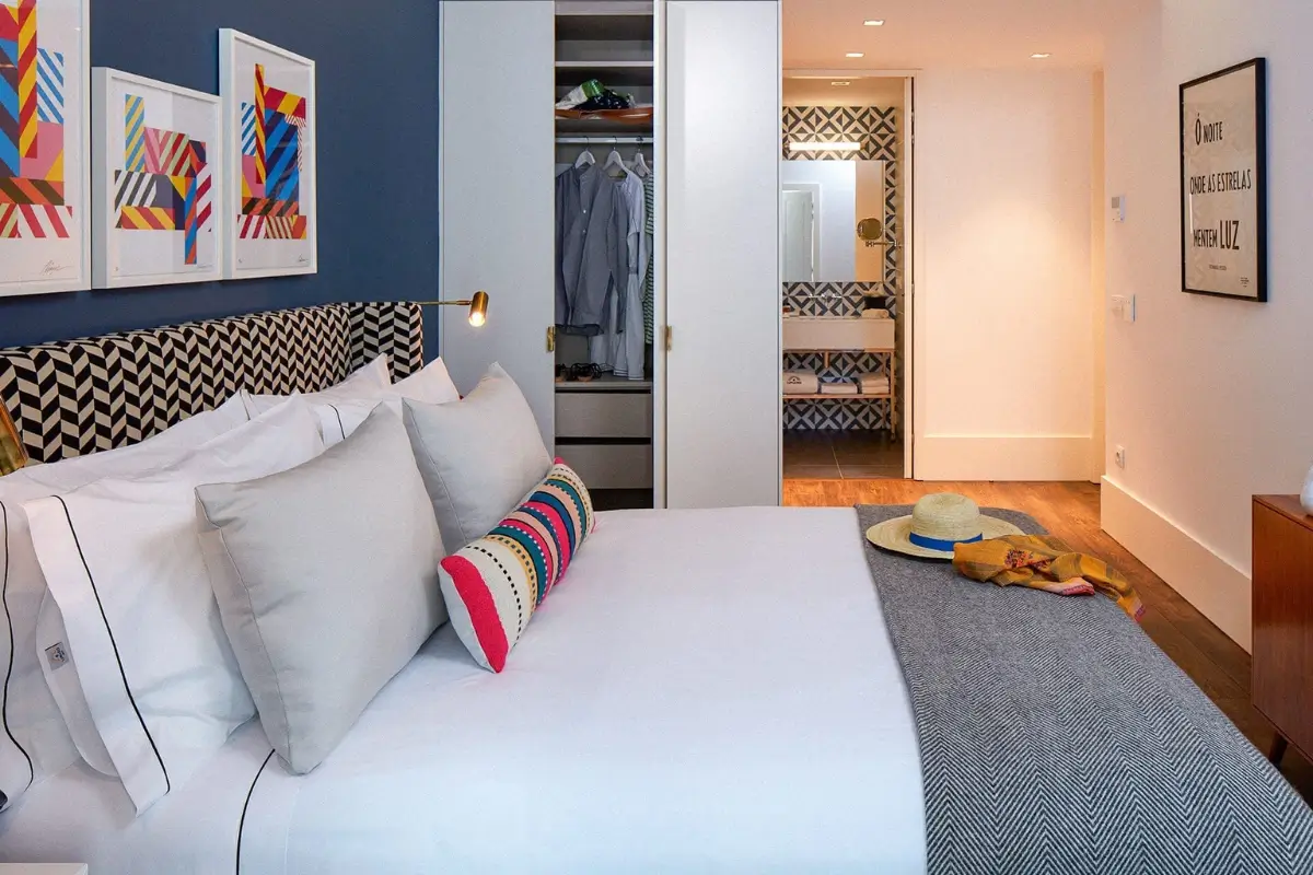 Boutique hotel bedroom with a patterned headboard.