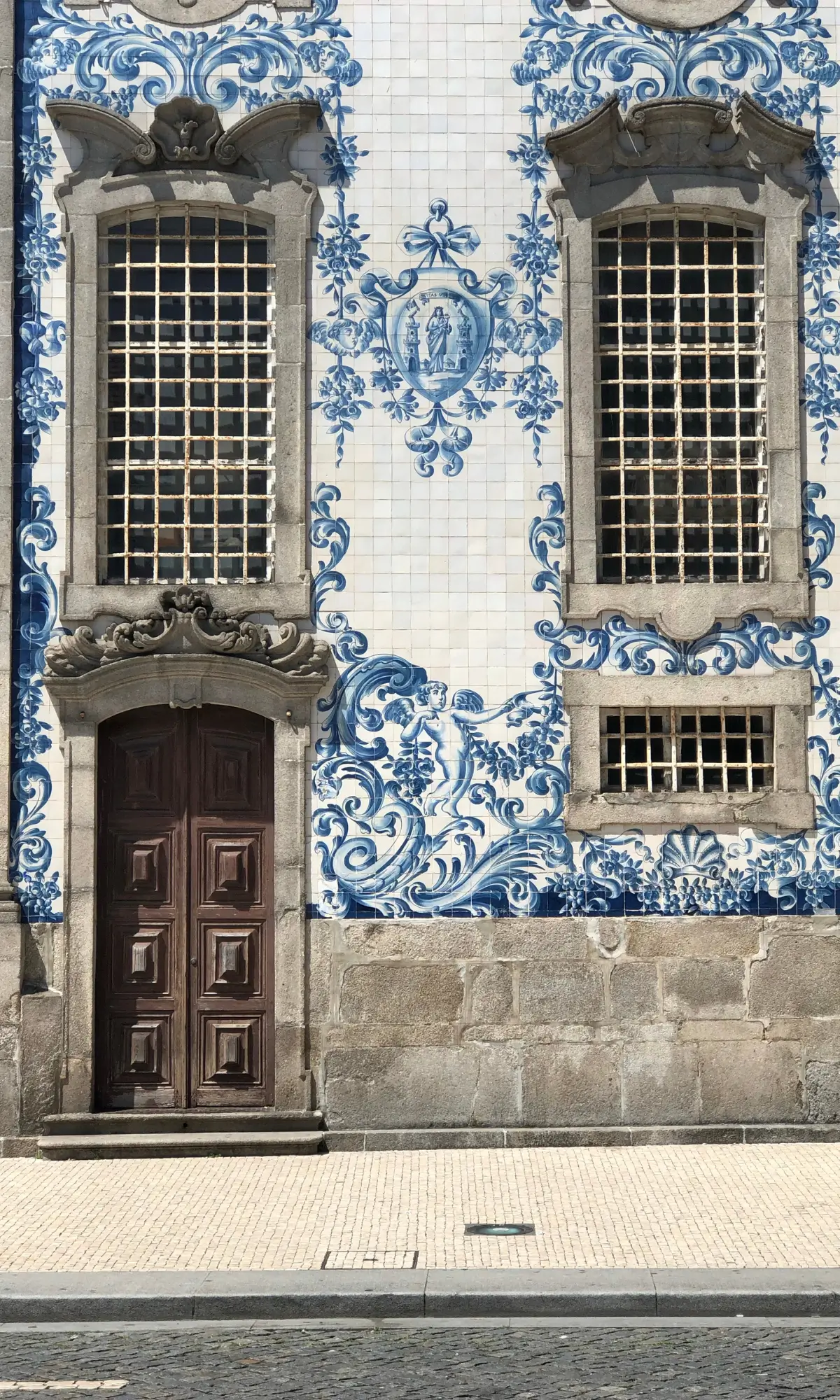 Blue and white azulejo tiles covering a historic building facade in Porto.