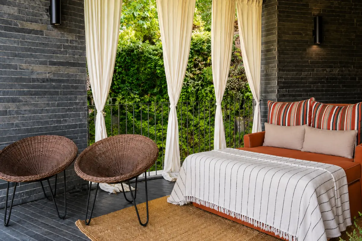 Private terrace at Quinta do Vallado with seating surrounded by greenery.