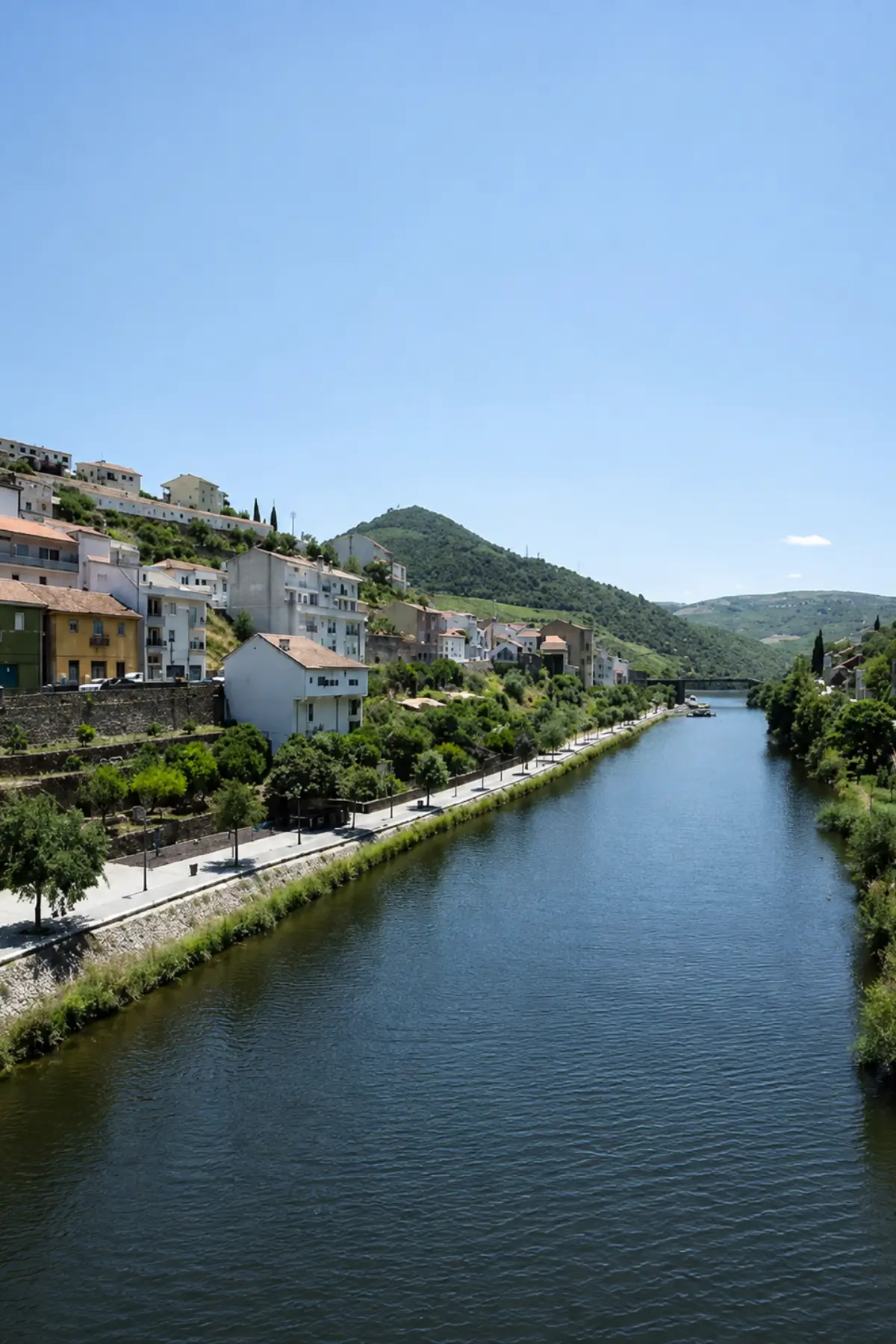 Riverside walking path beside a small town in the Douro Valley.
