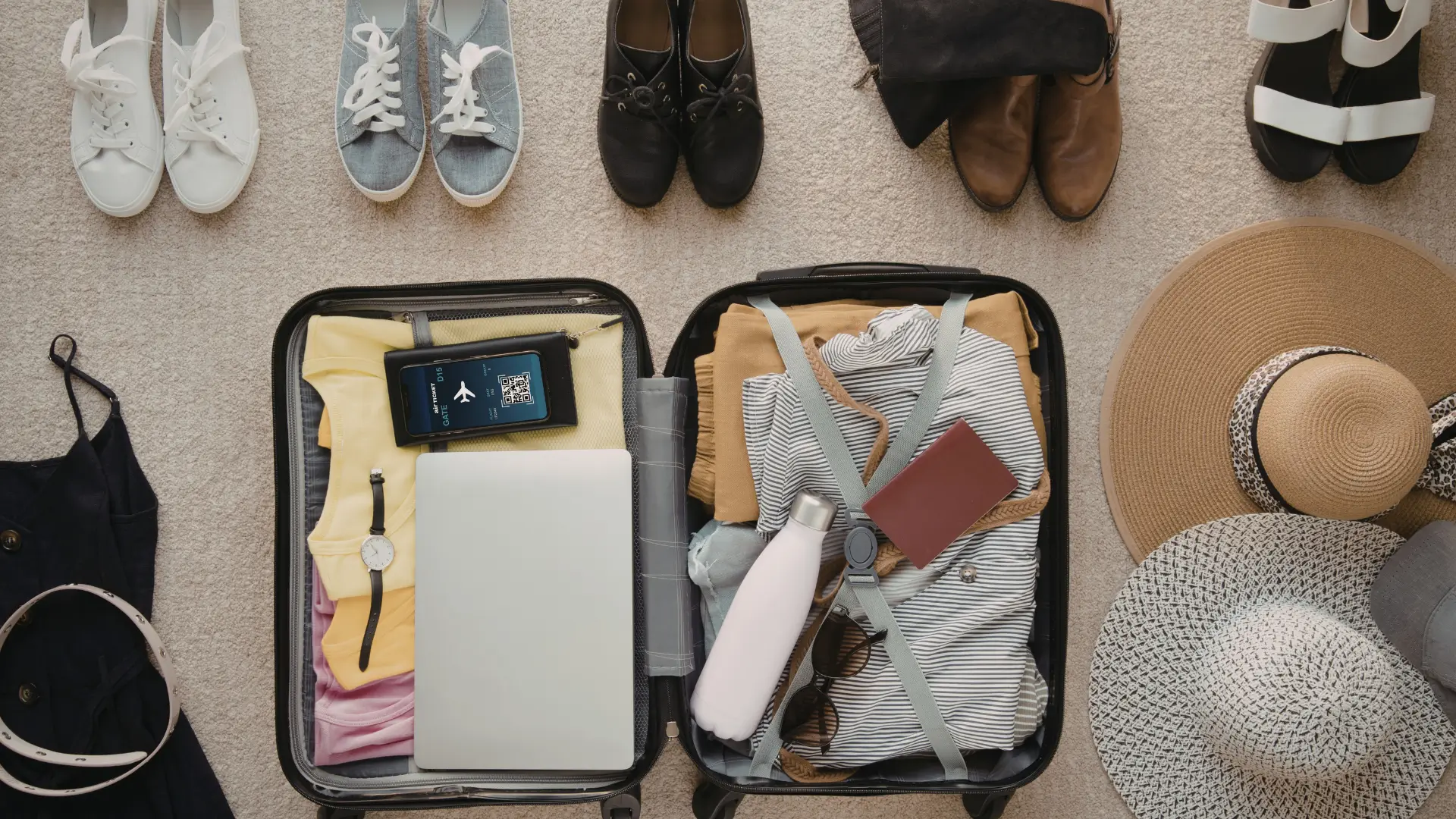 Open suitcase with clothing and travel essentials.