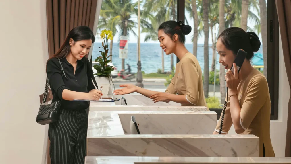 Traveller checking in at a hotel reception desk.