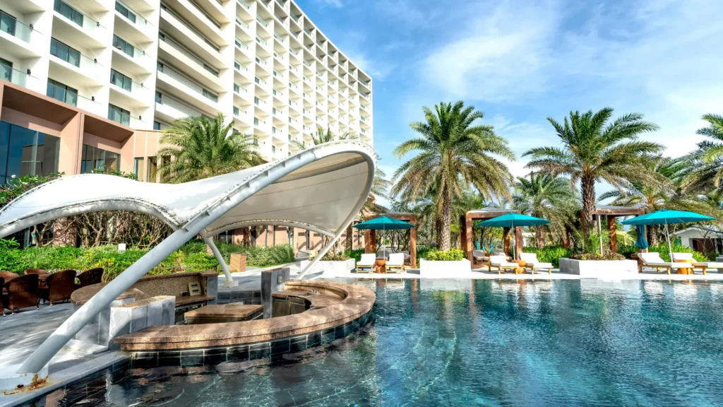 Resort hotel with swimming pool and palm trees